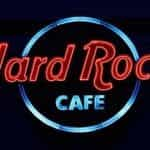 The highly recognizable and world-famous Hard Rock Café sign in red and blue neon lettering.