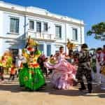 People in colorful dress dance during a celebration in Colombia.