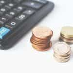 Coins next to a calculator.