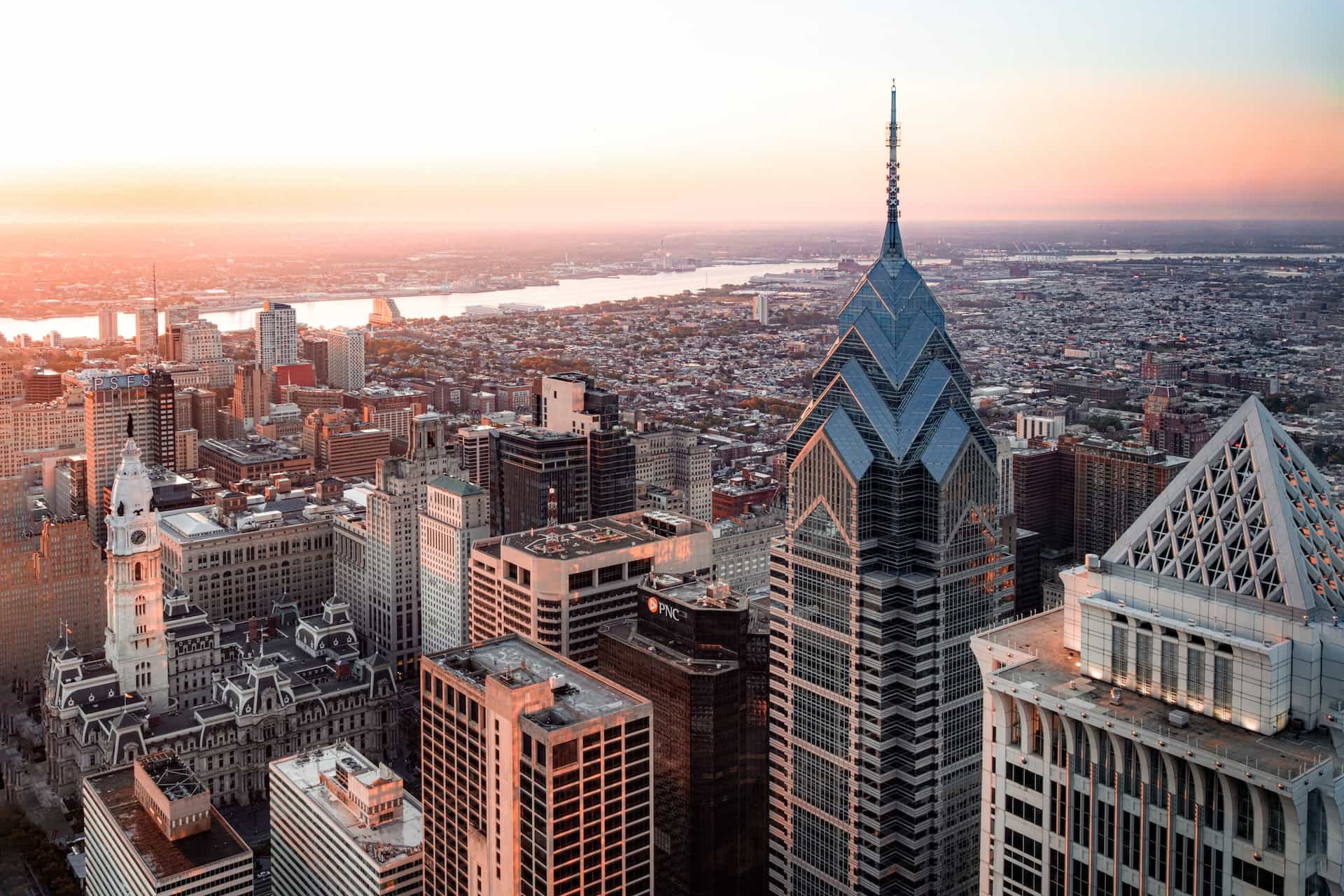 The Center City downtown area of Philadelphia in the US state of Pennsylvania, featuring several skyscrapers and tall buildings, with the rest of the city sprawling out beyond.